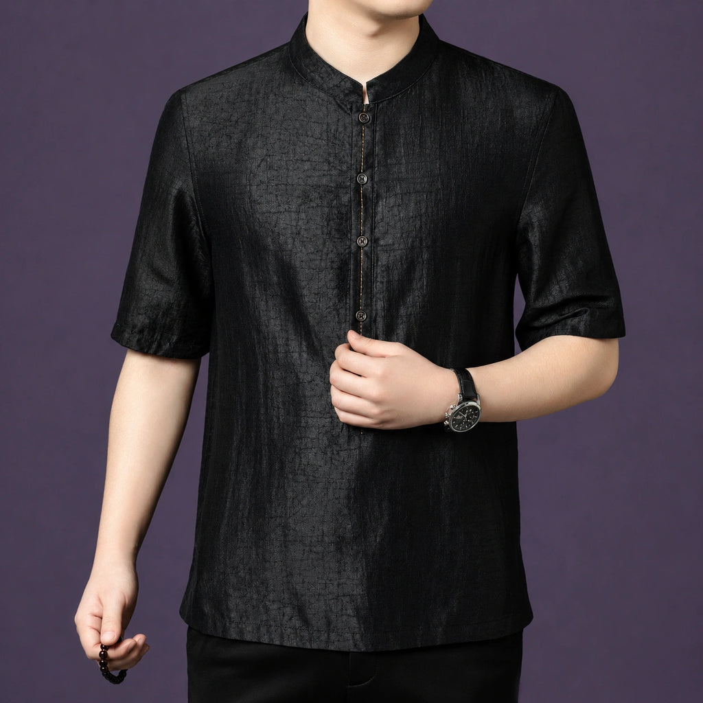 Close-up of the black silk shirt, showing the fine stitching details along the front placket and button accents.