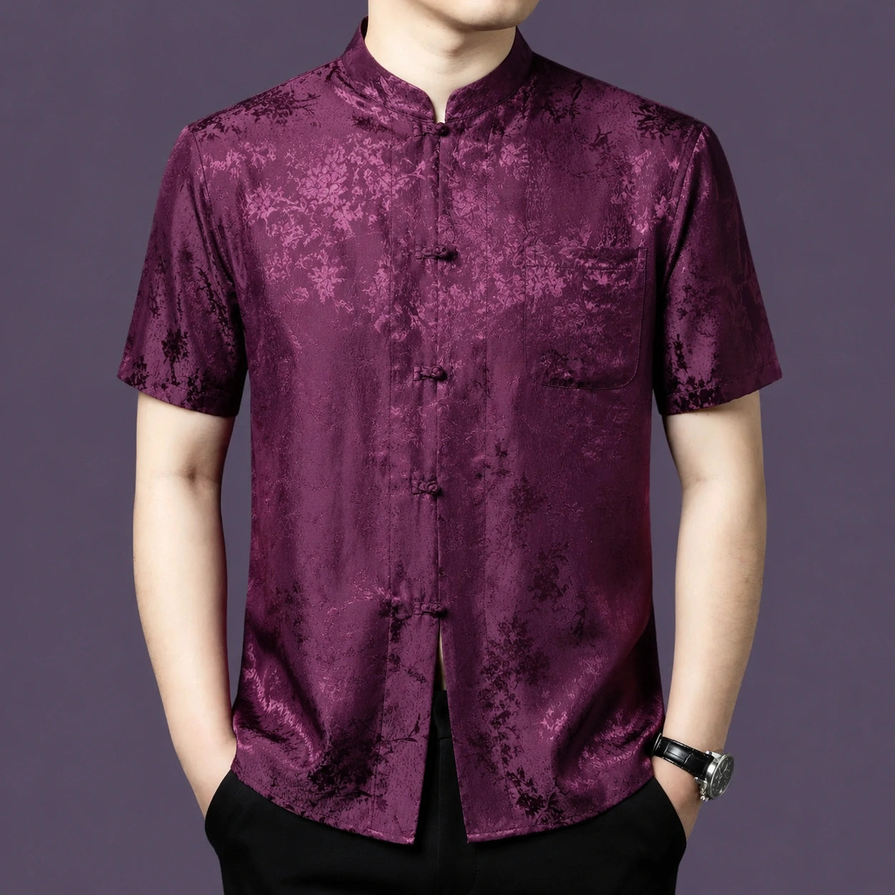 Men's burgundy 100% mulberry silk short-sleeve shirt with a stand collar and knotted button placket, showcasing a rich woven floral jacquard texture.