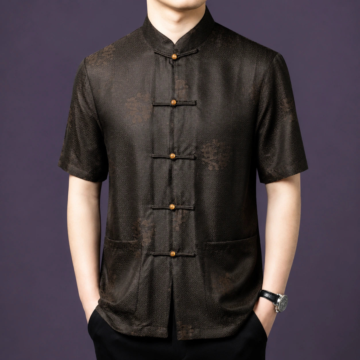 Men's dark brown 100% mulberry silk short-sleeve shirt featuring a traditional stand collar, geometric jacquard base pattern, and round wooden frog buttons.
