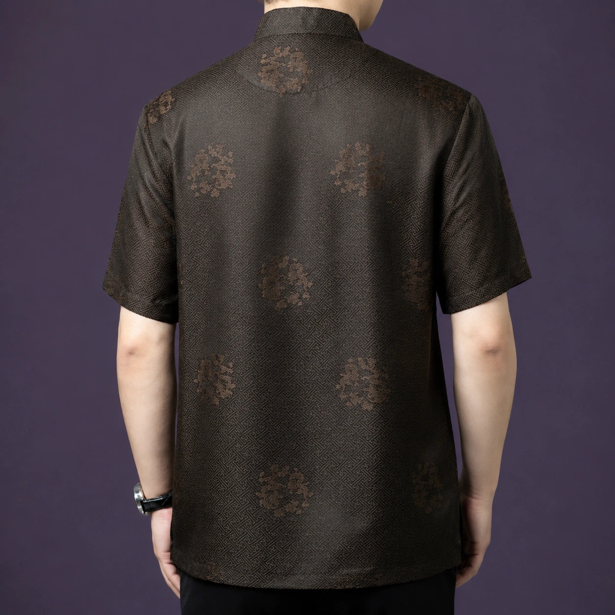 Back view of the dark brown silk shirt, showcasing the consistent geometric jacquard weave and scattered floral motifs across the entire fabric.