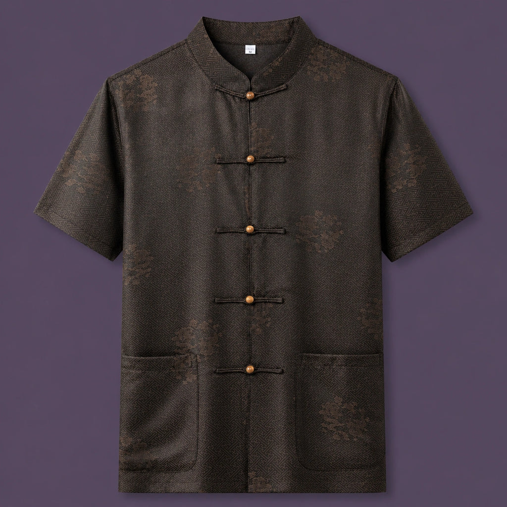 Flat lay of the men's short-sleeve silk shirt, showing the detailed geometric pattern, wooden button details, and patch pockets.