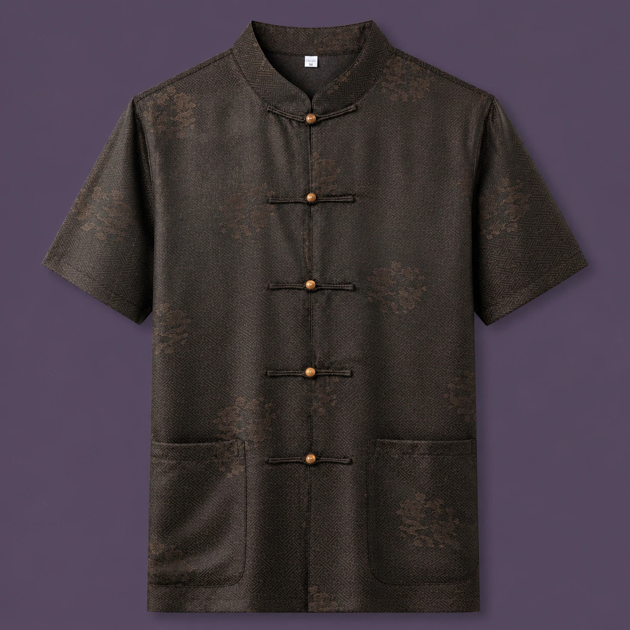 Flat lay of the men's short-sleeve silk shirt, showing the detailed geometric pattern, wooden button details, and patch pockets.