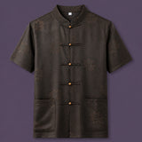 Flat lay of the men's short-sleeve silk shirt, showing the detailed geometric pattern, wooden button details, and patch pockets.