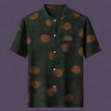 Flat lay of the men's short-sleeve silk shirt, featuring a stand collar, four front buttons, and a practical chest pocket.