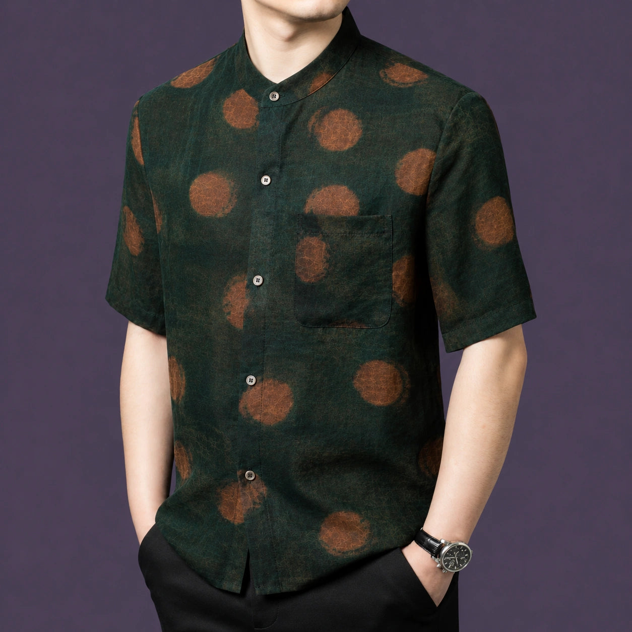 Front view of the green silk top, showcasing the relaxed straight cut and a single chest pocket on the left side.