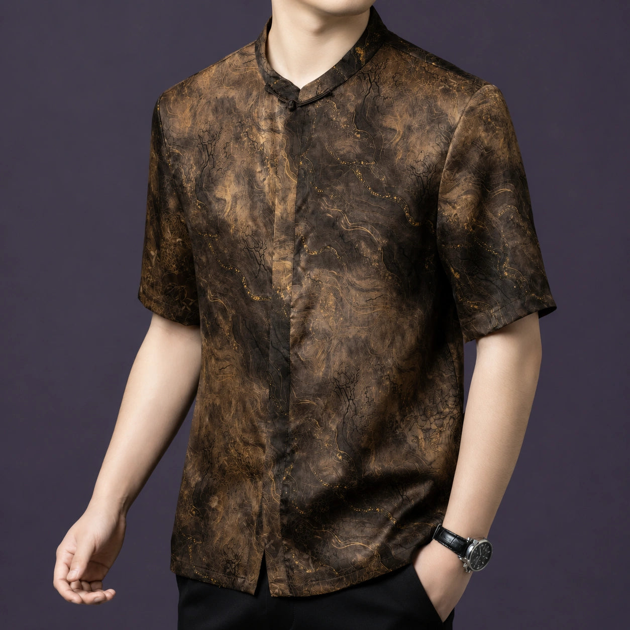 Front angle of the gold-marbled silk shirt, emphasizing the clean neckline and the understated, elegant drape of 100% silk.
