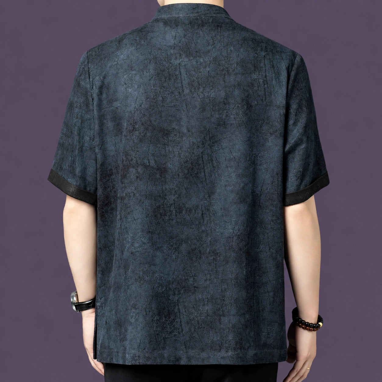 Back view of the grey silk shirt, showcasing the relaxed, straight fit and the continuous textured pattern across the back panel.