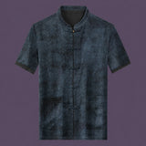Flat lay of the men's grey silk short-sleeve top featuring a mandarin collar, six frog buttons, two patch pockets, and contrast binding on the cuffs.