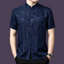 Men's navy blue 100% mulberry silk short-sleeve shirt with a traditional stand collar and a single patch pocket, featuring a tonal floral jacquard weave.