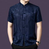 Men's navy blue 100% mulberry silk short-sleeve shirt with a traditional stand collar and a single patch pocket, featuring a tonal floral jacquard weave.