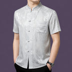 Alternate angle of the men's silver-grey silk shirt, highlighting the fine details of the button placket and the subtle light-reflecting jacquard pattern.