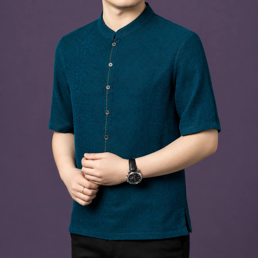 Front view of the teal silk shirt, highlighting the relaxed, straight cut and the side slit details at the hem.