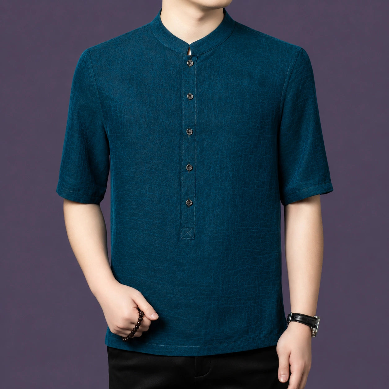 Men's teal blue 100% mulberry silk short-sleeve shirt with a stand collar and front button placket, styled with black trousers.