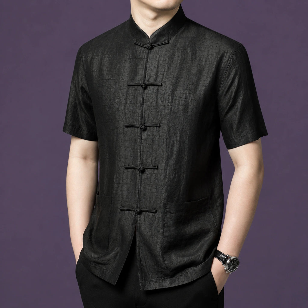 Side view of a men's black mulberry silk short sleeve shirt with mandarin collar and traditional frog button closure.
