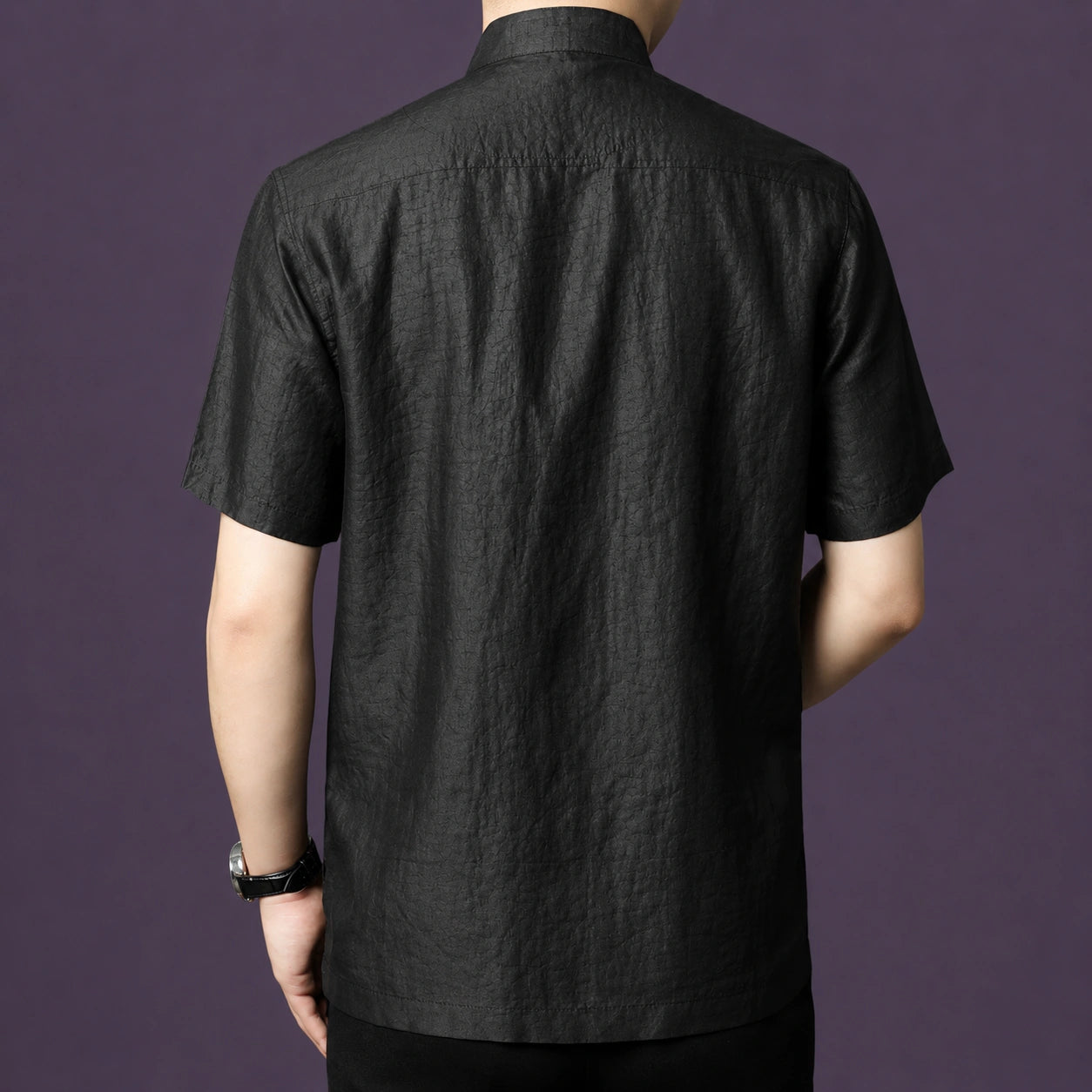 Back view of a men's black 100% mulberry silk mandarin collar short sleeve shirt.