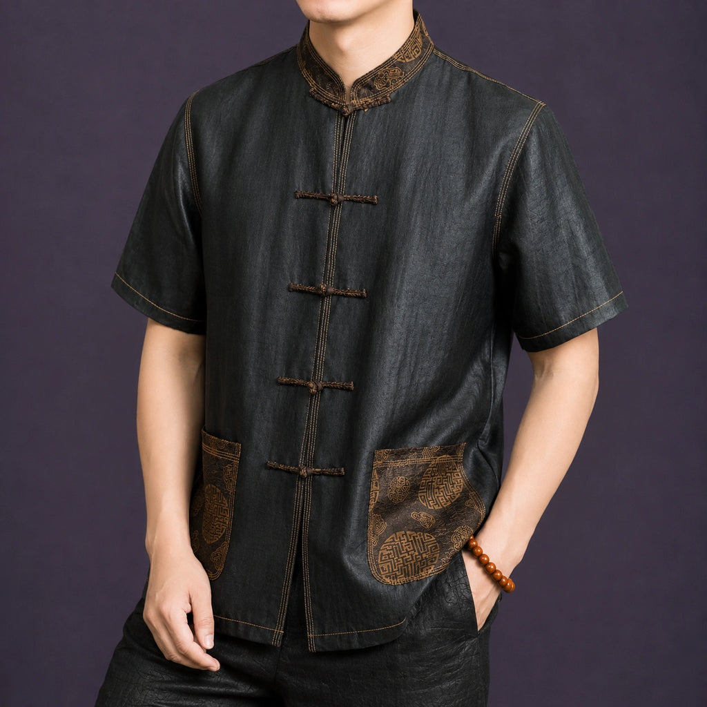 Angled view of a men's black mulberry silk Tang shirt featuring a Mandarin collar, frog closures and decorative contrast stitching.