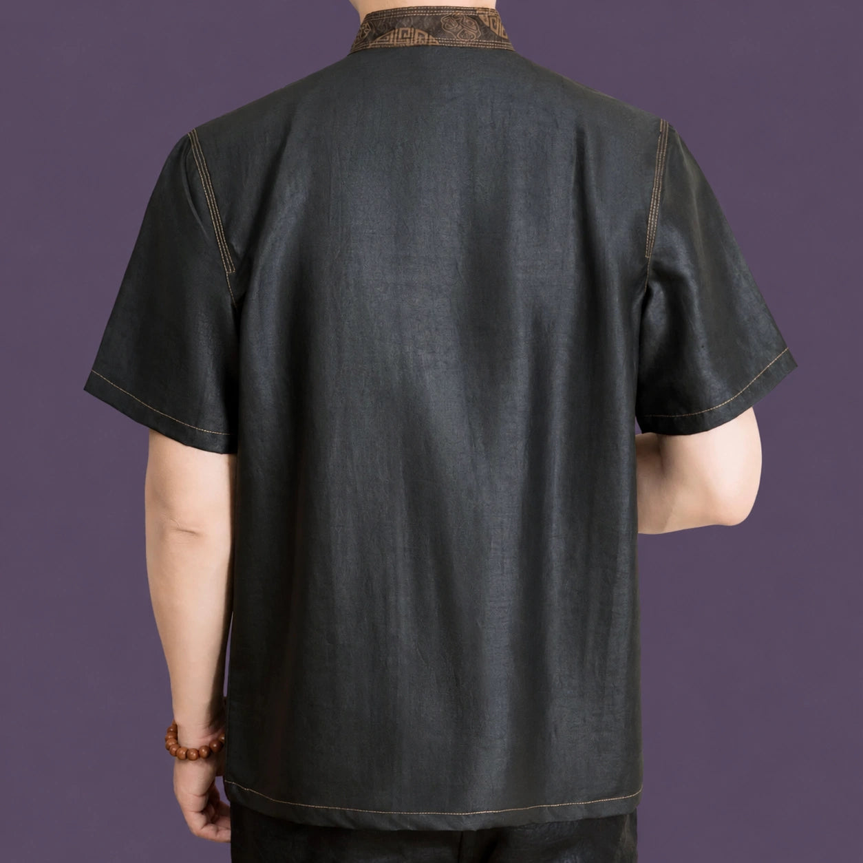 Back view of a men's black short sleeve mulberry silk Tang shirt with a clean, relaxed silhouette.