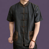 Model wearing a black 100% mulberry silk Chinese Tang shirt with short sleeves and traditional frog button fastening.