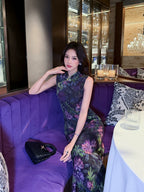 Woman wearing a Midnight Botanical Mulberry Silk floral Cheongsam dress while seated in an elegant restaurant.