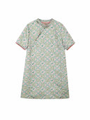 Flat lay of a mint green Chinese-inspired dress with a geometric floral print and round neckline