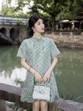 Model wearing a mint green silk-blend dress with a relaxed straight silhouette and patterned fabric