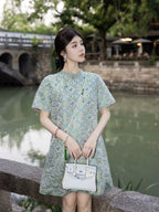 Model wearing a mint green silk-blend dress with a relaxed straight silhouette and patterned fabric