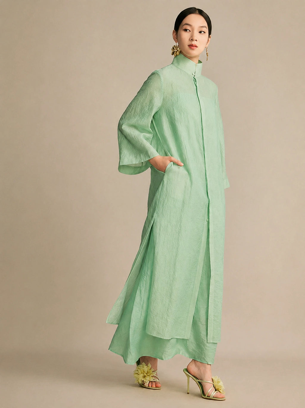 Side view of the mint green dress featuring an inseam side pocket and wide sleeves, demonstrating its lightweight, breathable fabric and comfortable fit.