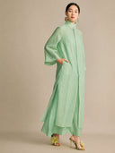 Side view of the mint green dress featuring an inseam side pocket and wide sleeves, demonstrating its lightweight, breathable fabric and comfortable fit.