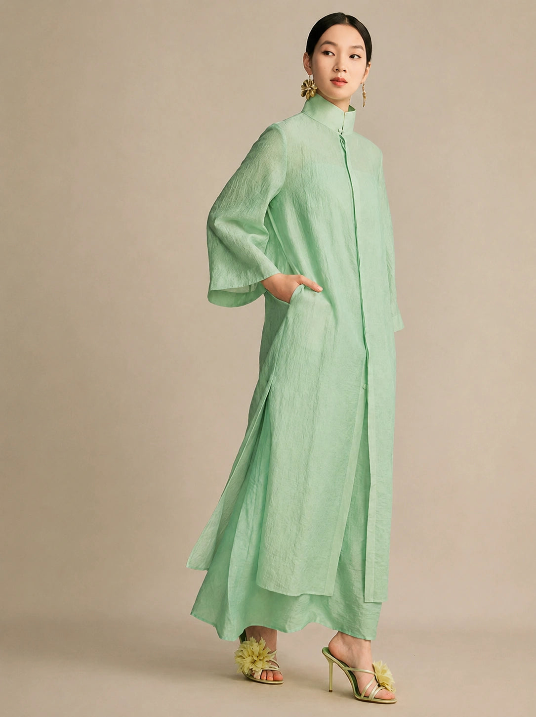 Side view of the mint green dress featuring an inseam side pocket and wide sleeves, demonstrating its lightweight, breathable fabric and comfortable fit.
