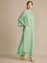 Side view of the mint green dress featuring an inseam side pocket and wide sleeves, demonstrating its lightweight, breathable fabric and comfortable fit.