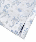 Close-up of the vest’s finished hem and blue-and-silver jacquard pattern.
