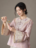 Model wearing the jacket, showing the embroidered front panel and wide patterned cuffs