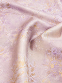 Close-up of the softly lustrous purple and gold floral jacquard fabric