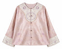 Front view of the jacket showing its embroidered neckline panel and wide cuffs