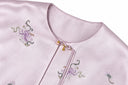 Close-up of the jacket’s round neckline, floral embroidery and decorative knot closure.