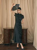 Women's black modern jacquard qipao dress featuring a mandarin collar and elegant draped silhouette.
