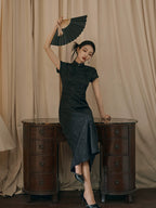 Black modern Chinese-inspired jacquard qipao dress styled with a traditional folding fan.