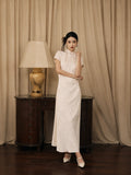 Women's ivory modern jacquard qipao dress with mandarin collar and short sleeves by Gambiered Silk.