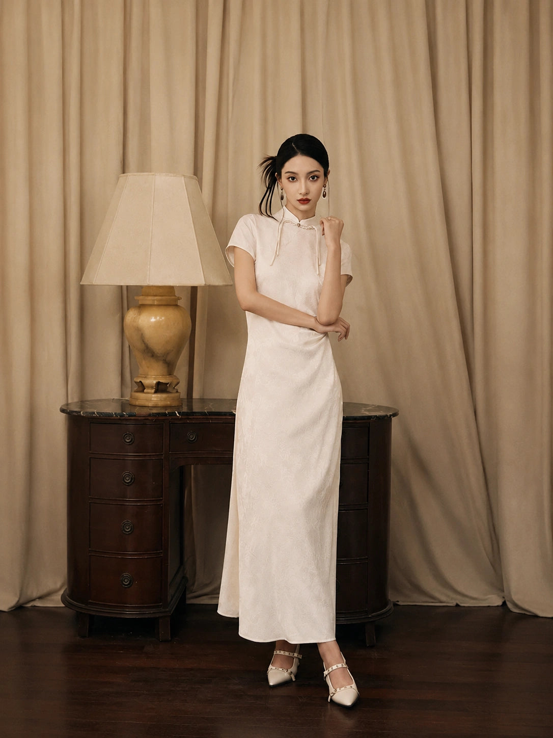 Women's ivory modern jacquard qipao dress with mandarin collar and short sleeves by Gambiered Silk.