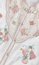 Close-up of the vest’s embroidered gourds and flowers, patterned front panel and pink buttons.