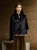 Model wearing the black mink fur side of the Moxu reversible vest over a black blouse.