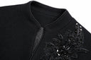 Close-up of the coat’s stand collar and floral bead embroidery.