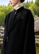 Close view of the coat’s stand collar, curved front edge and beaded shoulder embroidery.