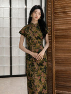 Woman wearing a 100% mulberry silk botanical print qipao maxi dress with stand collar and cap sleeves.