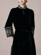 Close-up of the mandarin collar and brocade trim on a black mulberry silk dress