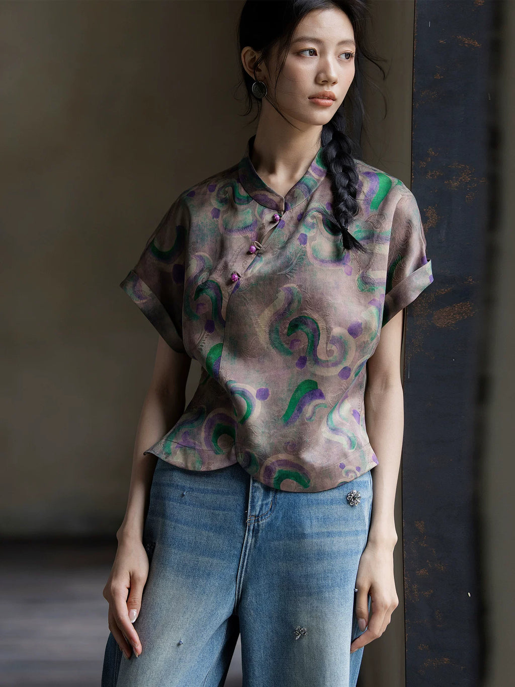 Close-up of a printed 100% mulberry silk Gambiered Silk blouse featuring a mandarin collar and handcrafted frog buttons.
