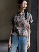 Close-up of a printed 100% mulberry silk Gambiered Silk blouse featuring a mandarin collar and handcrafted frog buttons.