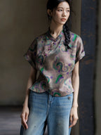 Close-up of a printed 100% mulberry silk Gambiered Silk blouse featuring a mandarin collar and handcrafted frog buttons.