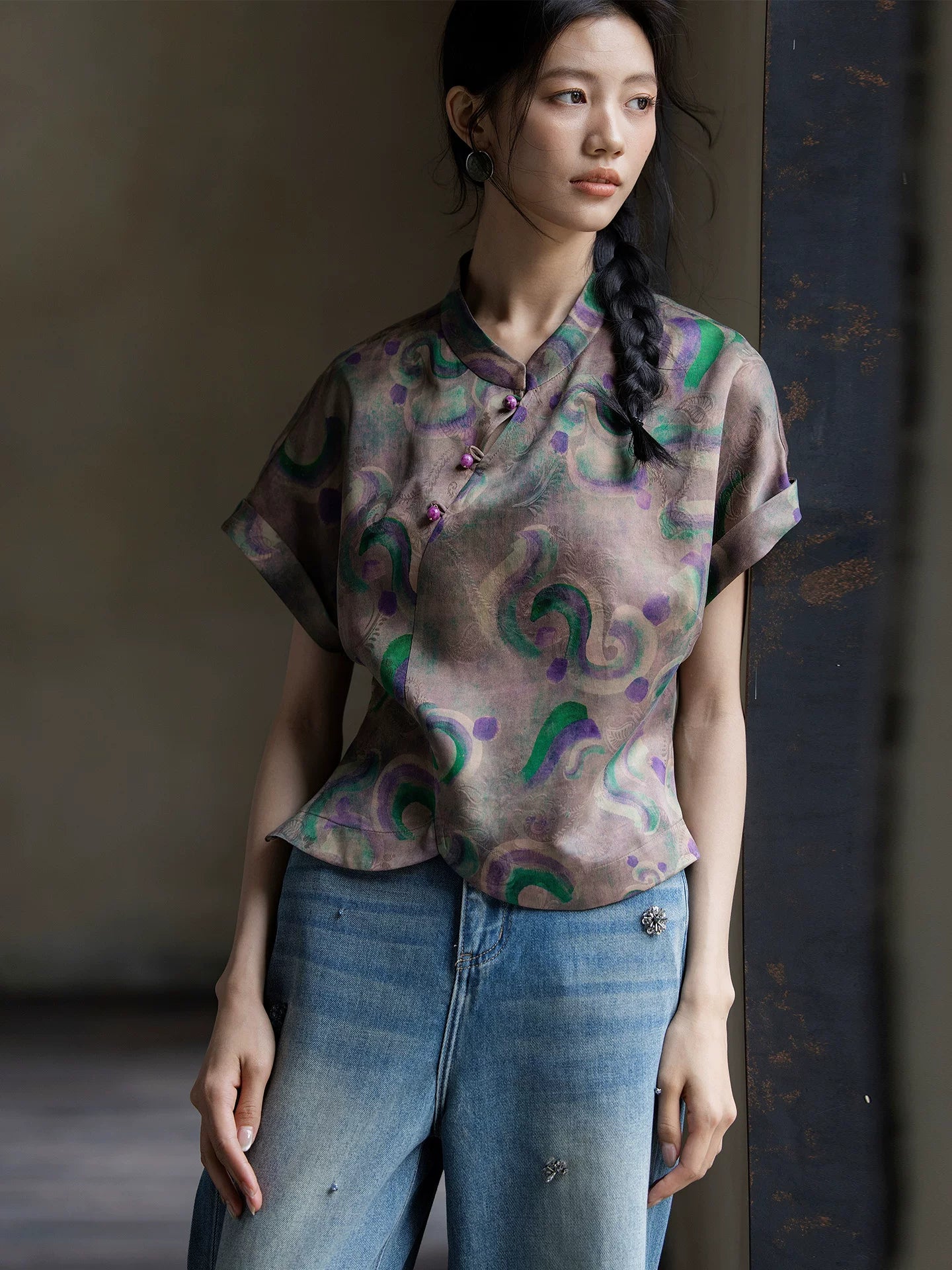 Close-up of a printed 100% mulberry silk Gambiered Silk blouse featuring a mandarin collar and handcrafted frog buttons.