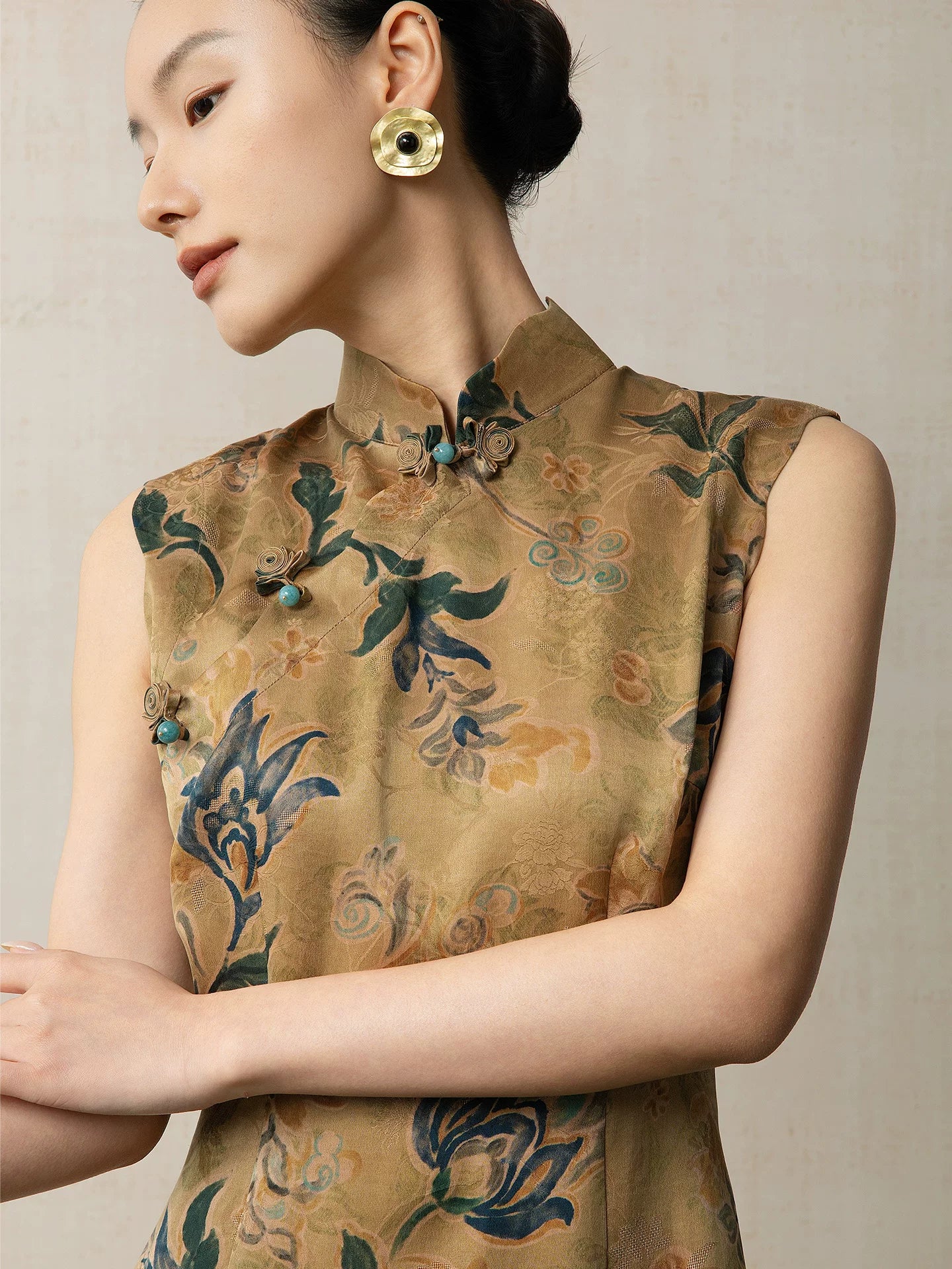 Close-up of the mandarin collar and handcrafted frog buttons on a floral silk qipao